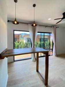 a wooden table in a room with a large window at Aonang Green Tree in Ao Nang 