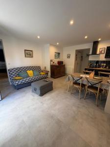 a living room with a bed and a table and chairs at Le Lavoir de Loches in Loches
