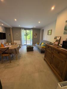 a living room with a table and a couch at Le Lavoir de Loches in Loches