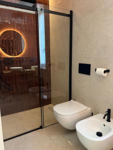 a bathroom with a toilet and a shower and a sink at Appartamento Nicole 20 in Menaggio +28 photos