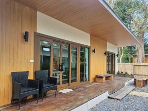 a porch of a house with chairs and a table at Aonang Green Tree in Ao Nang 