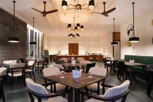 a restaurant dining room with tables and chairs at Nivasana Manali - A Luxury Boutique Hotel in Manāli