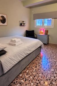 a bedroom with a bed and a chair and a window at The Citrus Yard in Politika, 2 bedrooms apartment in Politika