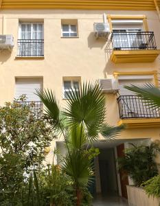 a building with balconies and palm trees in front of it at Beach Side Heaven in Fuengirola