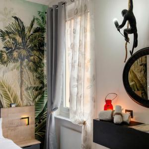 a room with a monkey on the wall next to a window at Janua Jungle House in Genoa +22 photos