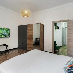 a bedroom with a large bed and a mirror at Janua Jungle House in Genoa