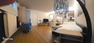 a bedroom with a bed and a desk and a chair at appartamento comfort Malpensa check in h 24 posto auto privato in Casorate Sempione