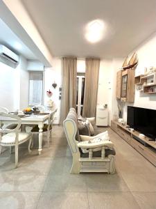 a living room with a table and a dining room at Princess Home in Marina di Massa +5 photos