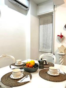 a dining room table with a bowl of fruit on it at Princess Home in Marina di Massa
