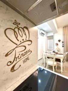 a kitchen and dining room with a sign that says happy home at Princess Home in Marina di Massa