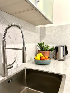 a kitchen counter with a sink and a bowl of fruit at Princess Home in Marina di Massa