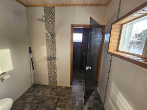 a shower with a glass door in a bathroom at Villa Sevettijärvi in Sevettijärvi