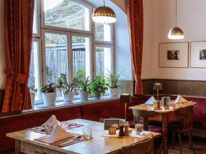 a restaurant with two tables and a window at Berghotel Franzenshöhe in Trafoi