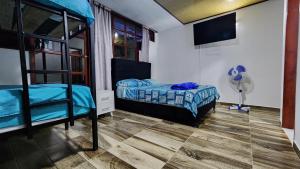 a bedroom with two bunk beds and a fan at Finca Casa Real la Vega in La Vega