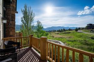 a wooden balcony with a view of a mountain at Bigfoots Alpine Retreat MH710By Powder Mtn Hot Tub in Eden