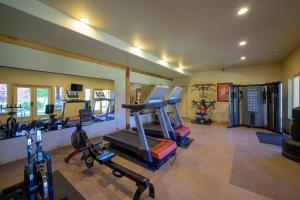 a gym with several treadmills and machines in it at Bigfoots Alpine Retreat MH710By Powder Mtn Hot Tub in Eden