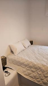 a bed with two pillows on it in a room at White and Blue in Mesimvría +56 photos