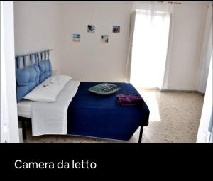 a bedroom with a blue bed in a room at Grande Procida in Procida
