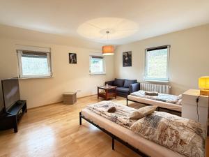 a living room with two beds and a couch at Ferienwohnung Mona Lisa in Malterdingen