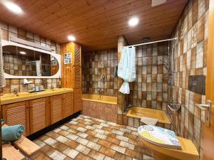 a bathroom with a toilet and a sink and a tub at Ferienwohnung Mona Lisa in Malterdingen +9 photos