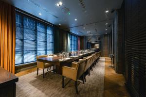 a long dining room with a long table and chairs at Dakota Manchester in Manchester