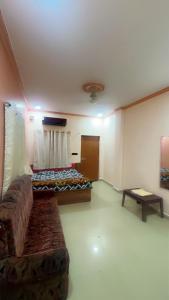 a living room with a couch and a table at Hotel kashish in Waigaon