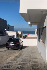 a car parked on a street next to a building at La corniche in Kenitra +7 photos