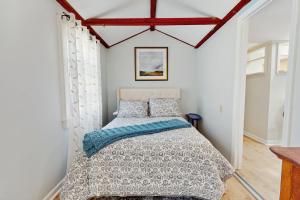 a bedroom with a bed in a room with white walls at 2 Mi to Dowses Beach! Couples Haven in Osterville in Osterville