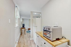 a kitchen with a stove and a refrigerator at 2 Mi to Dowses Beach! Couples Haven in Osterville in Osterville