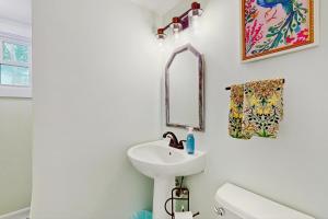 a bathroom with a sink and a mirror at 2 Mi to Dowses Beach! Couples Haven in Osterville in Osterville +16 photos
