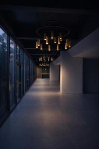 a dark room with a long hallway with chandeliers at Hotel B3 Sibelius in Chía