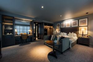 a bedroom with a bed and a couch and a table at Dakota Manchester in Manchester