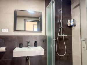 a bathroom with a sink and a shower with a mirror at Eurovea Tower Apartment 27th floor, Luxury bed VISPRING Baronet Superb in Ovsište +9 photos