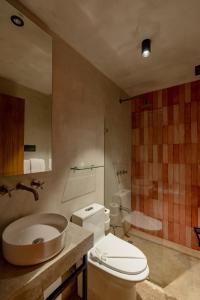 a bathroom with a toilet and a sink and a shower at The Surfer's Base in Jacó +35 photos