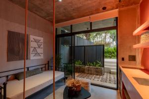 a room with a swinging bed and a large window at The Surfer's Base in Jacó