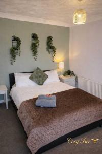 a bedroom with a bed with plants on the wall at Cosy Bee - Freemantle Solent Lodge in Southampton