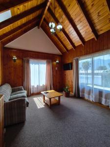 a living room with a couch and a table at Alpes Hotel in Pucón