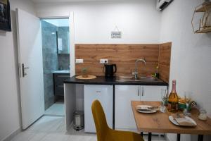 a kitchen with a sink and a table and a shower at Apartmani Prestige in Gornji Vakuf +11 photos