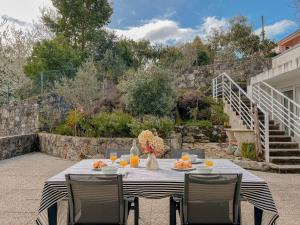 a table with food and orange juice on a patio at Casa das Rampas - Nature Retreat with Pool in Moledo
