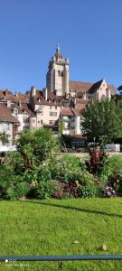 a large building with a castle in the background at Superbe duplex « le Grévy » in Dole