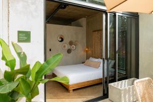 a bedroom with a bed and glass walls at The Digital Nomad Den in Jacó +46 photos