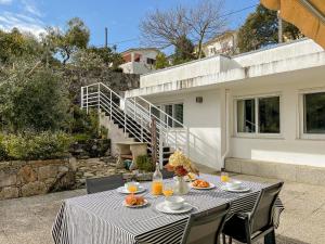 a table with plates of food on a patio at Casa das Rampas - Nature Retreat with Pool in Moledo