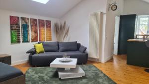 a living room with a blue couch and a table at Ferienwohnung Lottchen in Schwerin +2 photos