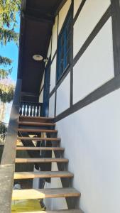 a staircase leading up to a building with a blue door at Ferienwohnung Lottchen in Schwerin