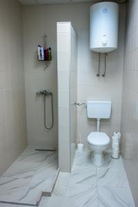 a bathroom with a shower and a toilet in it at Apartmani Prestige in Gornji Vakuf