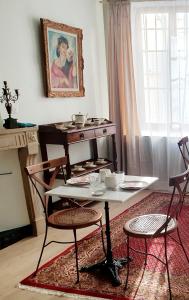 a room with a table and two chairs and a table at La demeure Langroise in Langres
