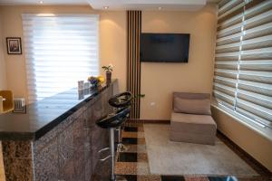 a hotel room with a reception desk and a chair at Apartmani Prestige in Gornji Vakuf