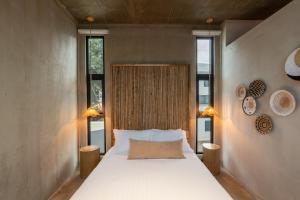 a bedroom with a large bed and two windows at The Terrace Retreat in Jacó +33 photos