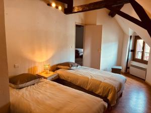 a bedroom with two beds in a room at Levroux - maison 4-6 pers - cour privee in Levroux