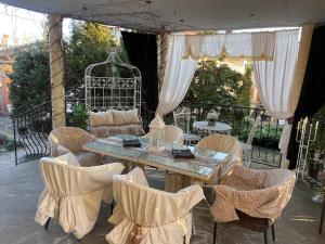 a table and chairs on a patio with a gazebo at Hotel Domashnii in Zhytomyr